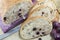 Fruit bread with aronia sliced on a wooden plate with dried aron