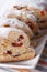 Fruit bread Stollen sliced macro on a white plate. vertical