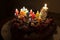 A fruit cake with candles for a sixth birthday.