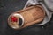 Fruit cake on tumbled stone floor and wooden presentation