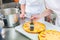 Fruit cakes being made by two pastry bakers