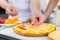 Fruit cakes being made by two pastry bakers