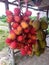 The fruit commonly called rambutan which is hung and sold in traditional markets