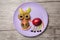 Fruit donkey on purple plate and wooden background