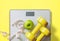 Fruit, dumbbell and scale, fat burn and weight loss