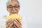 The fruit of durian peeled and ready to eat in the hands of the old elderly on white background,happy asian senior woman eating