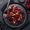 Fruit fig, grape, raspberry and pomegranate salad on black plate