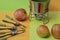 Fruit forks, dessert spoons, ceramic fondue dishes and red apples on a colored background