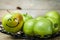 Fruit. fresh green apples in plate on wooden background. with a smile on apple