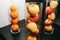 Fruit in glass vases standing on the table. apples and oranges in decorative interior design. Fresh vegetarian vitamins