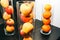 Fruit in glass vases standing on the table. apples and oranges in decorative interior design. Fresh vegetarian vitamins