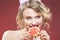 Fruit Ideas. Shy and Caucasian Blond Girl Biting Grapefruit