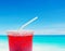 Fruit juice on defocused beach background