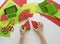 Fruit made of craft paper. Children`s hands