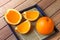 Fruit Oranges full and slice on plates and on wood table with lighting and shadow