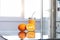 Fruit oranges and orange juice at the kitchen interior and transparent glass table on the light rays white background