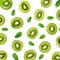 Fruit Pattern - Creative layout made of Kiwi fruits and peppermint leaves. Many slices of ripe Kiwifruit. Flat lay.