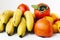 Fruit plate on white background. Mandarins, bananas, persimmons and lemons