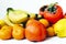 Fruit plate on white background. Mandarins, bananas, persimmons and lemons