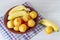 Fruit plate on the white background. Peaches and bananas on a plate