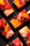 Fruit popsicles, homemade fruit ice lolly of various fruits with the addition of citrus lemonade on a black background, top view.