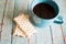 Fruit raspberry strudel pastry on teal wood background with a teal cup of raspberry tea.