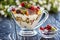 Fruit salad closeup with berries, yogurt and granola in a glass bow