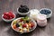 fruit salad, fresh berries and yoghurts on a wooden table