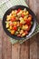 Fruit salad with orange, kumquat, pineapple, carambola, grapefruit, plum and kiwi close-up. vertical top view