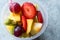 Fruit Salad with Strawberry, Kiwi, Mango and Grape in Plastic Cup.