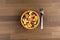 Fruit Salad in Wooden Bowl with a Fork on Wooden Table, Centered