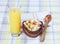 Fruit salad in a wooden bowl, orange juice.