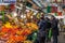 Fruit seller and buyers in the interior of the historical Bolhao Market