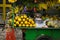 Fruit seller display various kind of exotic tropical fruit like banana and papaya on green cart photo taken in Depok