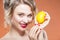 Fruit Series. Closeup Portrait of Happy Naked Caucasian Blond Girl With Lemon Fruit.