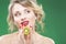 Fruit Series. Portrait of Curious Caucasian Blond Model Posing With Kiwi Fruit