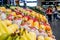 Fruit shop greengrocer display shelf with exotic fruits - mangoes, oranges, dragonfruits, bananas