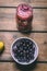 Fruit smoothies made with fresh ingredients on a wooden background. Black currant, banana. Healthy food concept