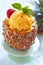 Fruit sorbet ice cream in small pineapple