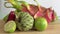 Fruit spin on wooden background. Close up footage of exotic fruit: Halved passion, dragon, annona, custard apple, guava
