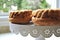 Fruit sponge cakes served on a decorative dish on a kitchen counter top.