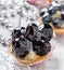 Fruit tarts with berries and strawberry on light background close up.