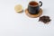 fruit tea in a black mug on a bamboo support, lemon segment and dried tea isolated on white background. Copyspace