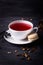 Fruit tea and coffee creme macaron on dark background