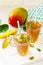 Fruit tea cups. Iced tea mango with mint