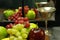 Fruit tray, silver wine glass with reflection through mirrored window