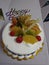 Fruit vanilla birthday cake with cherries and choco sticks