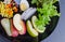 Fruit and vegetable salad on black plate