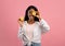 Fruit vitamins for skincare. Attractive black lady covering her eye with cut lemon on pink studio background