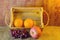 Fruits (apple, orange , grape ) in an wood box, on sack sisal background
